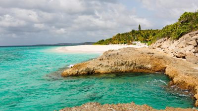 Rocky point and turquoise water along Meads Bay in Anguilla