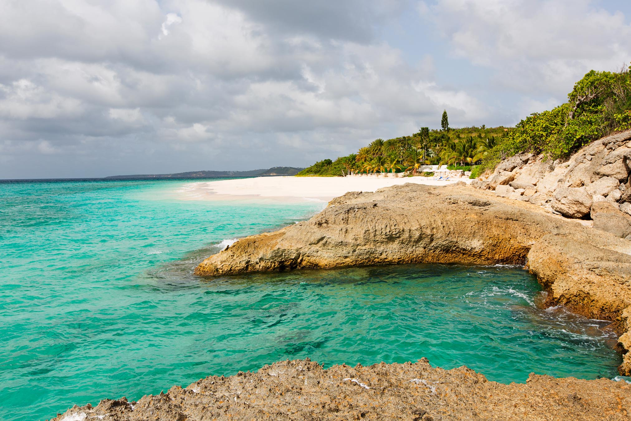 Rocky point and turquoise water along Meads Bay in Anguilla