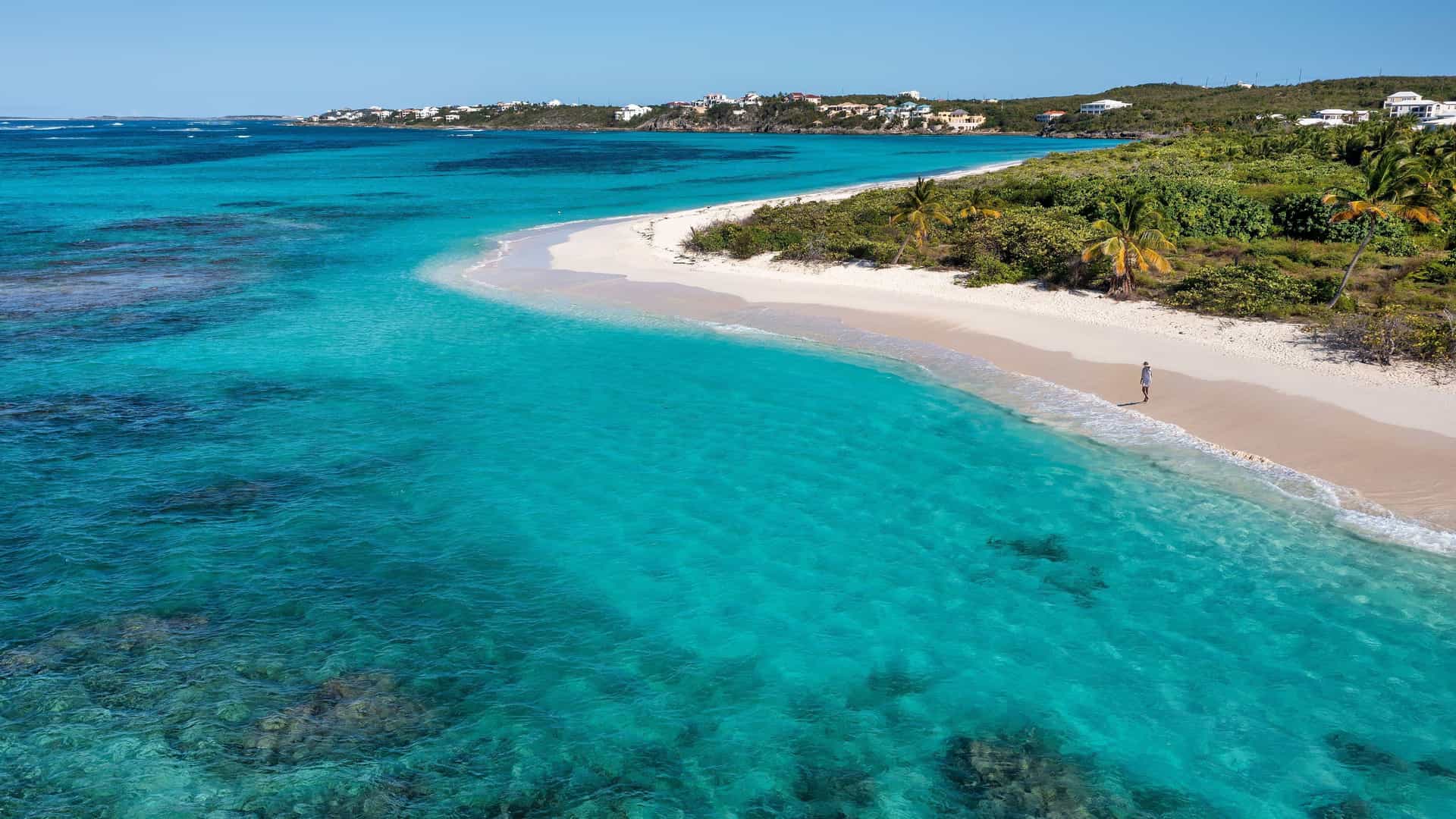 Road Bay, Anguilla, a calm turquoise beach with a coral reef visible near shore