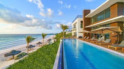 A beachfront villa with a private infinity pool overlooking the ocean, the kind of layout that suits multigenerational Bahamas trips