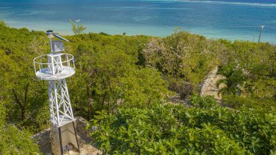 Aerial view of the East End lighthouse beacon and coastal reef in Grand Cayman