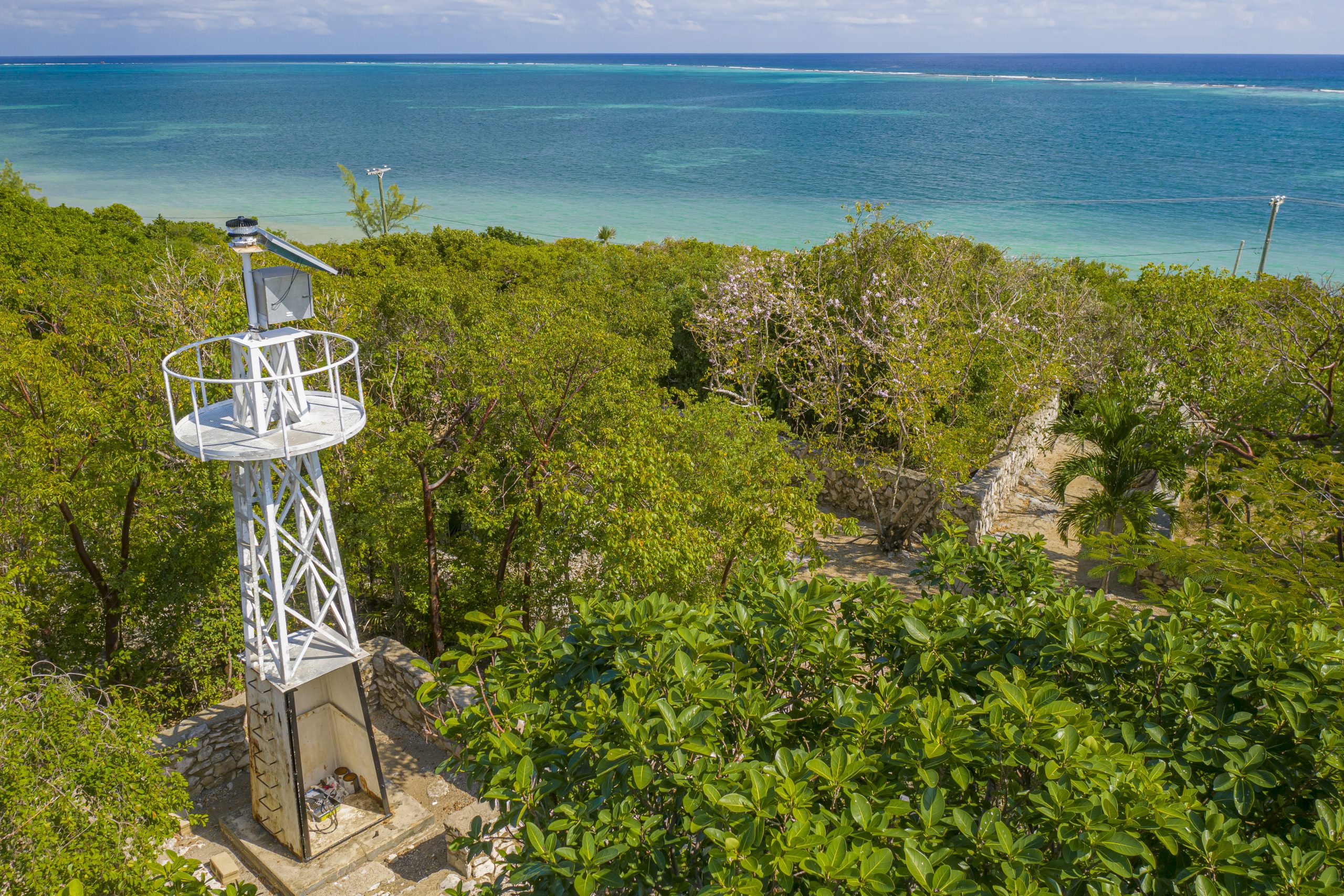 Aerial view of the East End lighthouse beacon and coastal reef in Grand Cayman