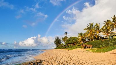 Rainbow over palm-lined Lanikai Beach in Oahu