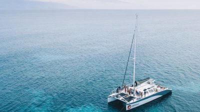 Snorkel catamaran anchored in clear turquoise water off Maui