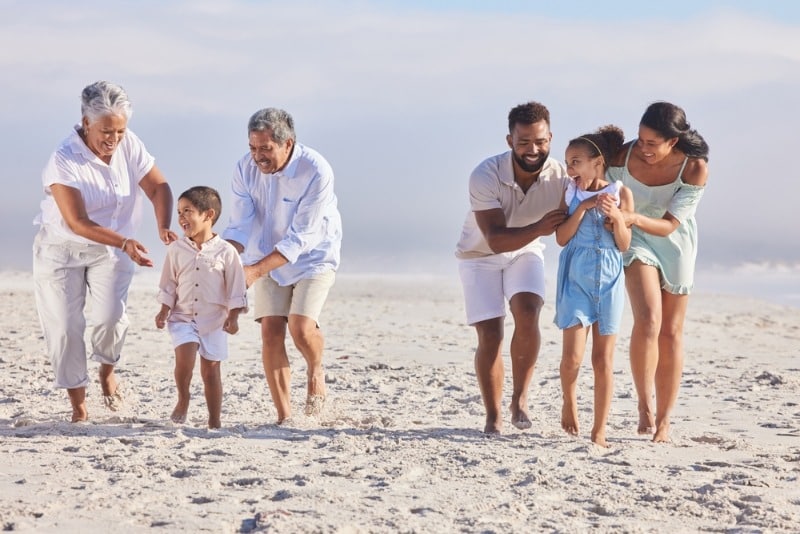 Three generations of a family walking together on a beach