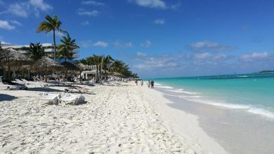 Calm, shallow turquoise water and white sand at Cable Beach in Nassau, Bahamas