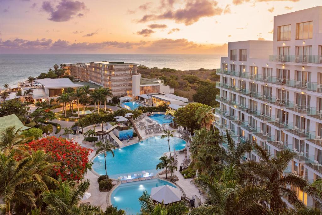 Sonesta Maho Beach Resort pools and waterslide at sunset in Sint Maarten