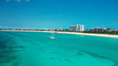 Sunny day over Grace Bay, Providenciales, with clear turquoise water and beachfront resorts