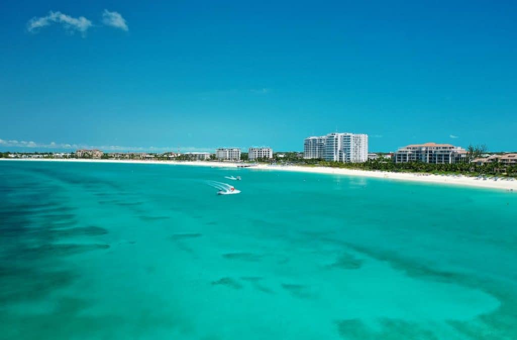 Sunny day over Grace Bay, Providenciales, with clear turquoise water and beachfront resorts