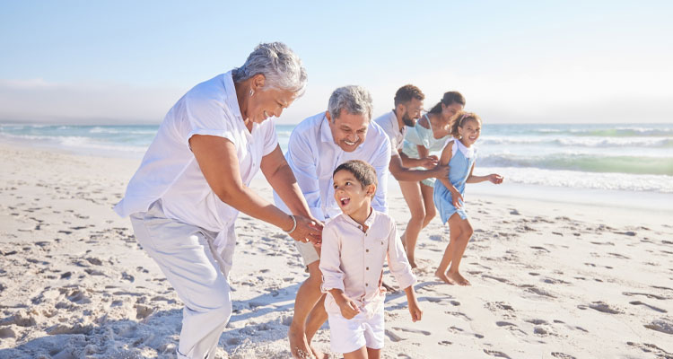 Three generations of a family playing together on a beach in Turks and Caicos