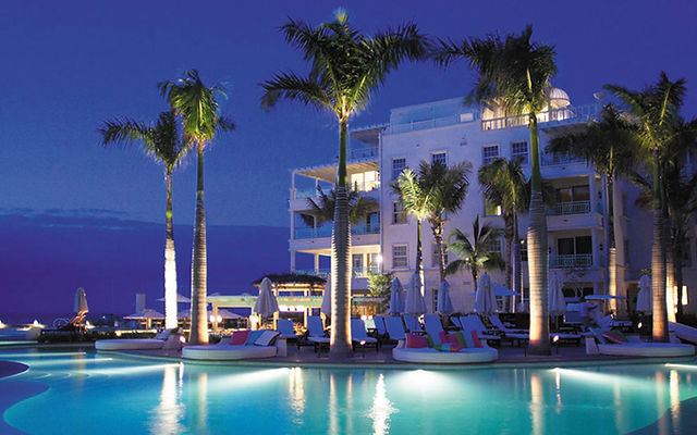 The Palms Turks and Caicos pool and resort building at dusk
